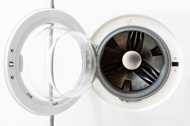 Open front-loading dryer with the door swung to the side, showing the empty interior drum. The appliance has a clean, white exterior with a clear glass door, set against a plain white background.